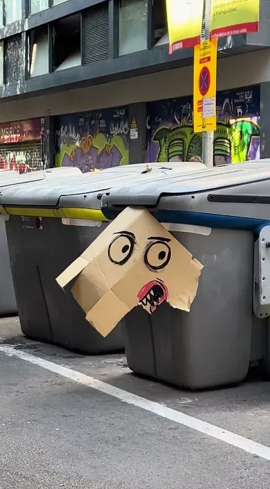 Pappkarton mit Gesicht auf Müllcontainern, Barcelona, Art Is Trash